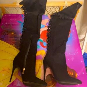 Long black thigh high boots.